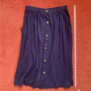 Navy midi skirt with button closures and nautical buttons